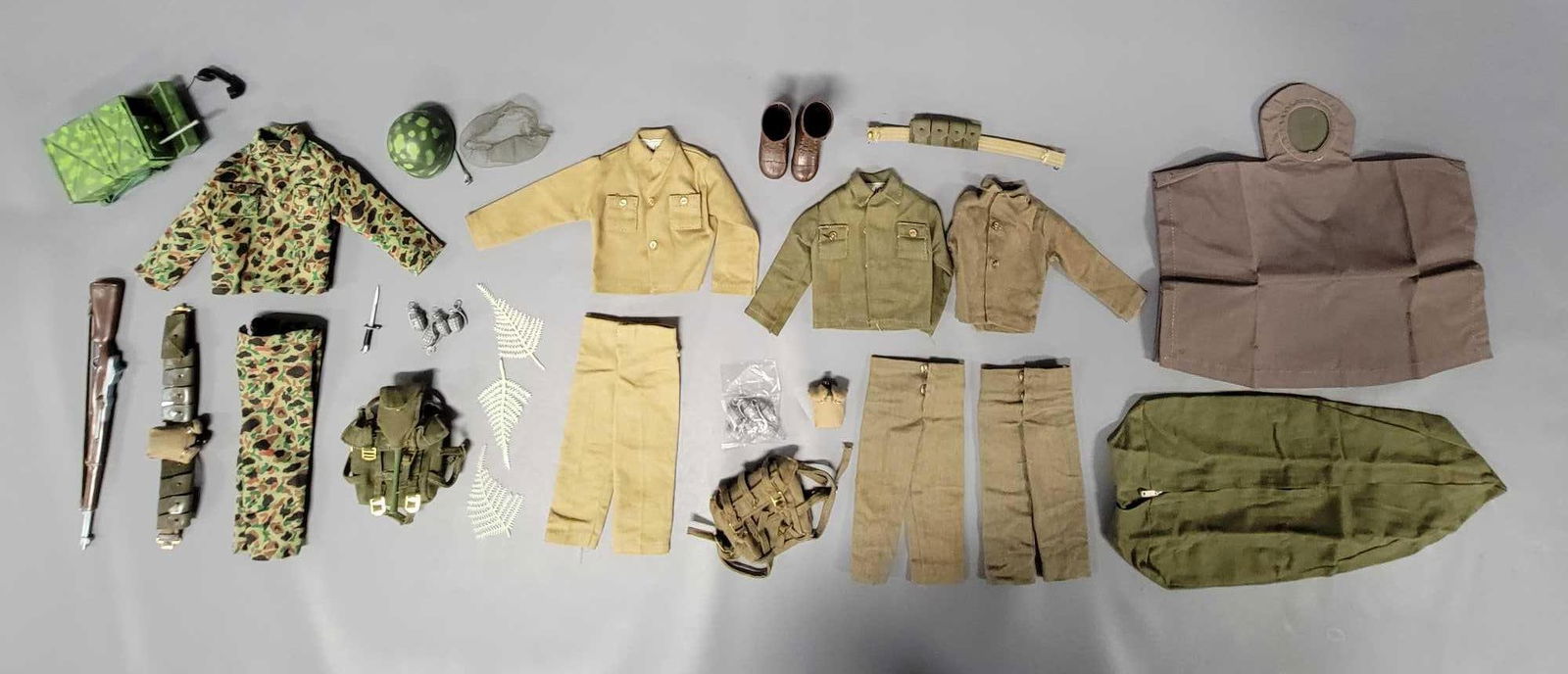 Group of vintage Hasbro GI Joe soldier and Marine accessories plus AT outfit: Group of vintage Hasbro GI Joe soldier and Marine accessories plus a black adventurer outfit. Soldier pieces include two pairs of pants, two shirts, backpack, unused poncho, brown plastic boots, tan b