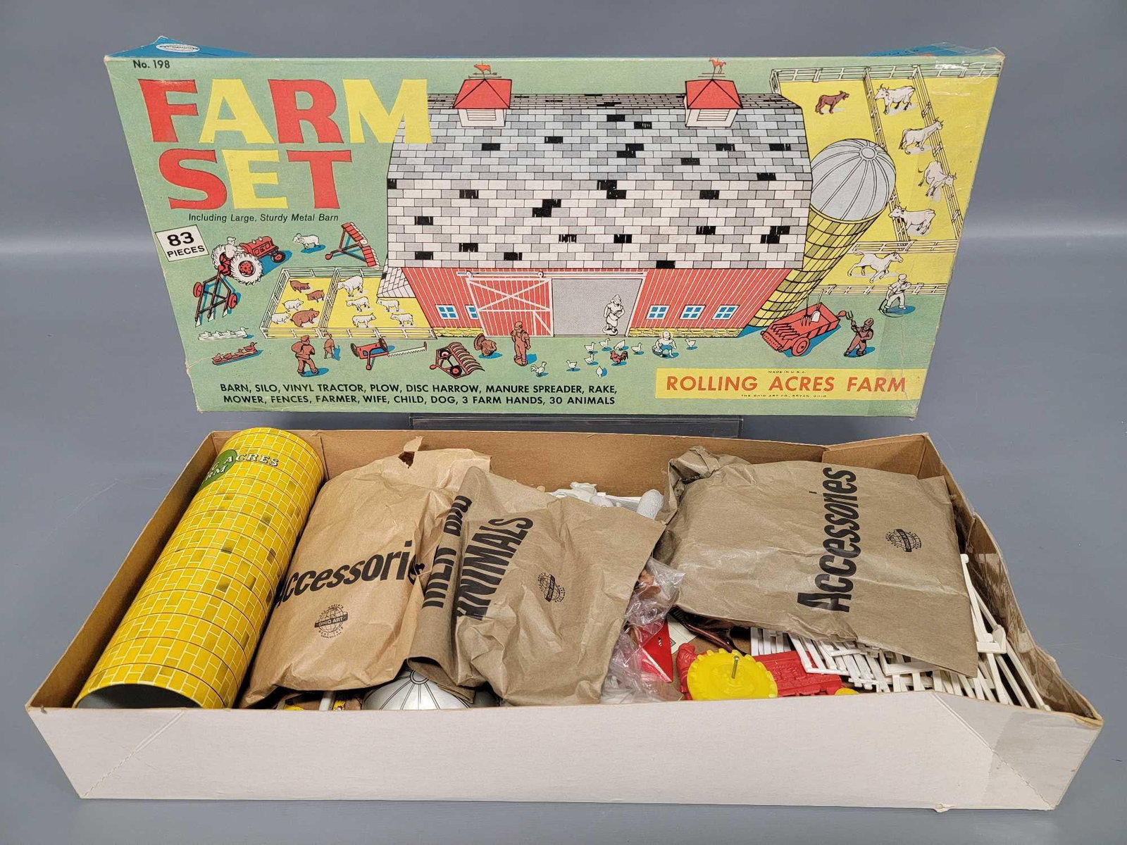 New unused Ohio Art Rolling Acres tin lithographed farm set in original box: New unused Ohio Art Rolling Acres tin lithographed farm set in original box, stock number 198. The tin has never been folded and is C9, there are numerous plastic parts and they are all unused with ma