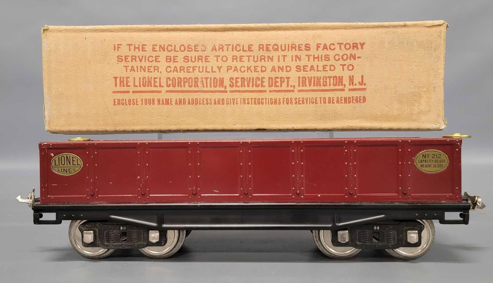 Nice Lionel prewar standard gauge wine 212 gondola in original box: Nice Lionel prewar standard gauge wine 212 gondola in original box with brass plates and brake wheels; nickel journals, C6+ in an excellent original box.