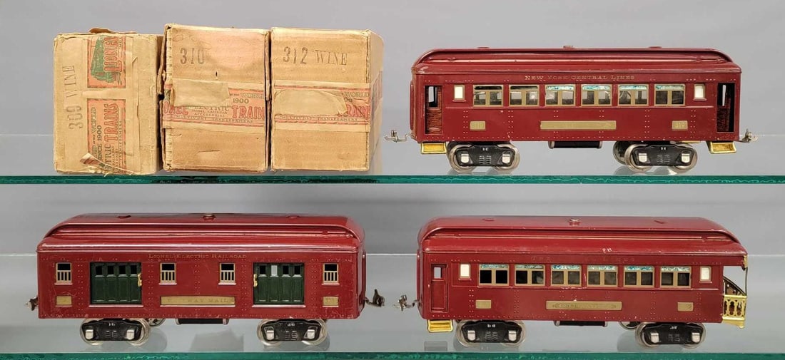 Lionel prewar O gauge maroon 319 320 322 passenger cars with 309 310 312 original boxes: Lionel prewar O gauge maroon 319 320 322 passenger cars with 309 310 312 original boxes. Includes 319 baggage, 320 Pullman coach and 322 observation, C7 with some crazing. Comes with good 309 and very