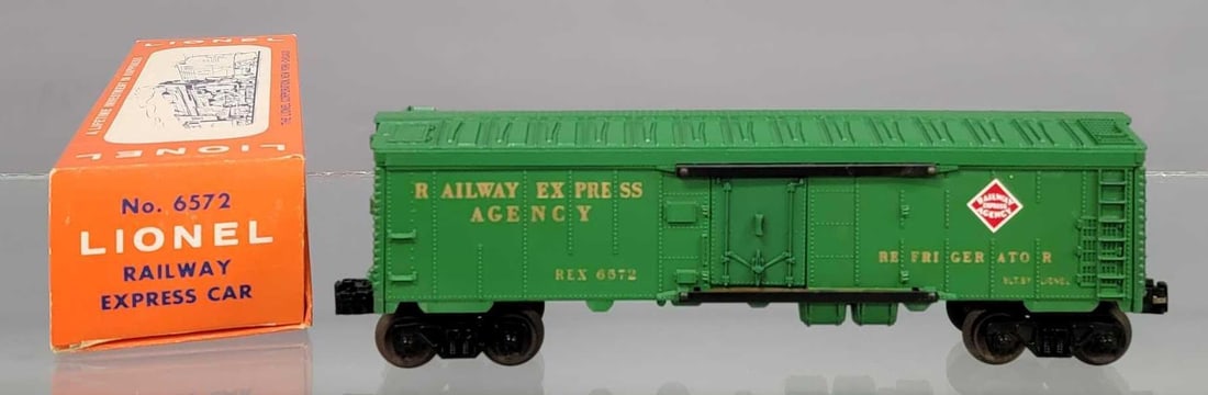 Unrun Lionel postwar 6572 Railway Express car in brick original box: Unrun Lionel postwar 6572 Railway Express car with AAR trucks in brick original box, Car is C8-9 with unrun trucks but the axles are dark with remnants of oxidation and rust. The box is complete, soli