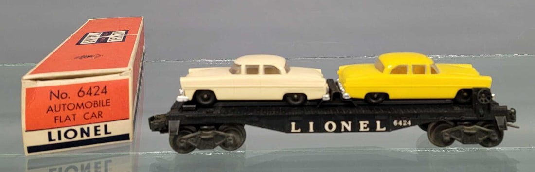 Lionel postwar 6424 automobile flat car in original box: Lionel postwar 6424 automobile flat car in original box, car show moderate run time and is C6-7 with two original autos, on yellow and one cream. Comes in a good original box that is solid and square 