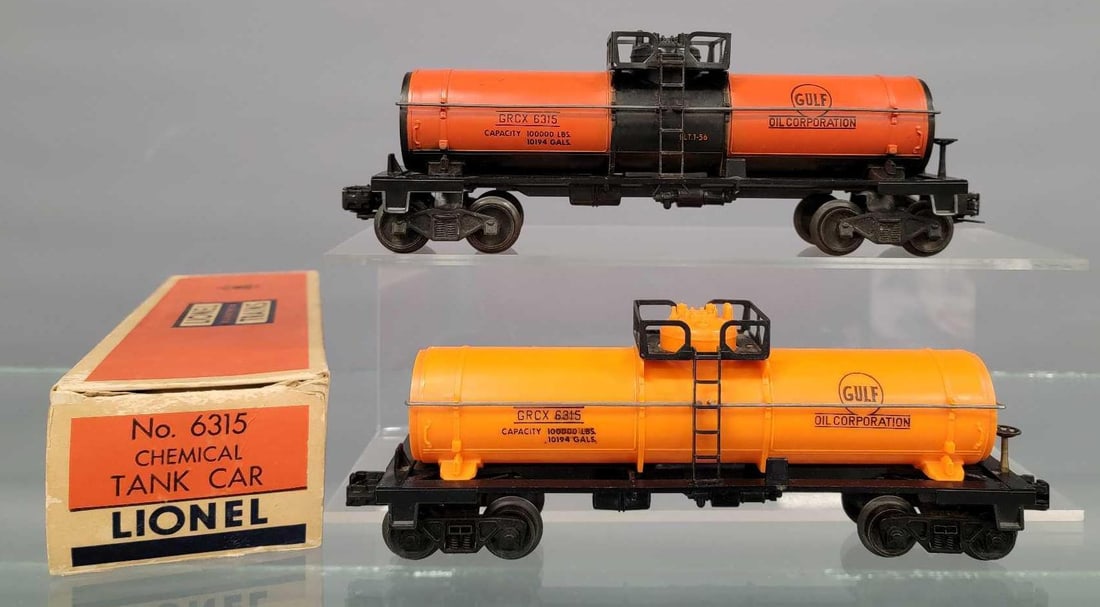 Two Lionel postwar 6315 Gulf tank cars with one original box: Two Lionel postwar 6315 Gulf tank cars with one original box. Includes a burnt orange example that is not glossy with bar end trucks and a molded orange example with AAR trucks, both show moderate run