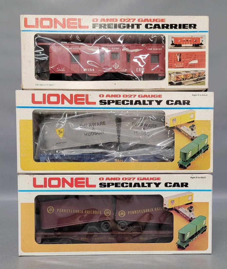 Three Lionel MPC era freight cars in original boxes: Three Lionel MPC era freight cars in original boxes to include 16303 Pennsylvania plus 9226 Delaware and Hudson flat cars with trailers and a 9184 Erie bay window caboose, C9 in excellent original box