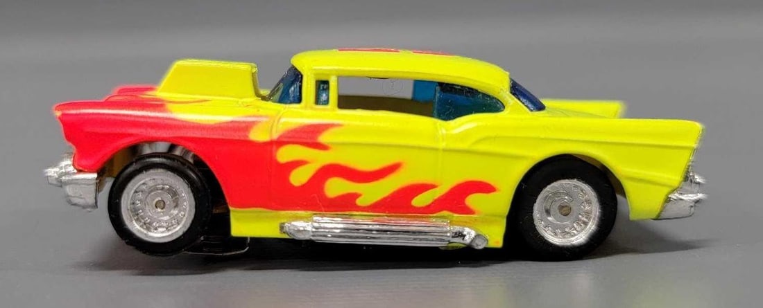 Tyco 57 Chevy HO slot car #53: Tyco 57 Chevy HO slot car #53, neon green with orange flames, near mint to mint condition, unrun chassis. This has been tested with a 9 volt battery and runs perfectly.