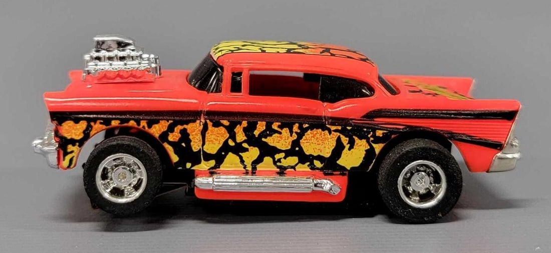 Tyco 57 Chevy HO slot car neon orange Venom: Tyco 57 Chevy HO slot car neon orange Venom, excellent to near mint condition on an unrun chassis. This has been tested with a 9 volt battery and runs perfectly.