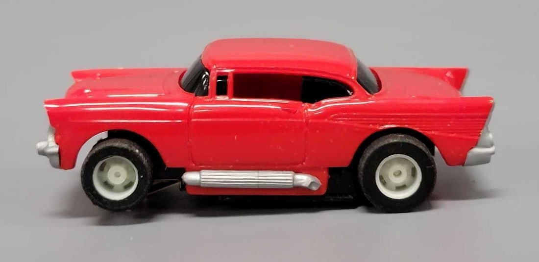 Tyco HO 57 Chevy Slot Car red: Tyco HO 57 Chevy Slot Car in red. It features a bright red body, silver exhaust pipes, chrome bumpers and is in excellent to near mint condition on an unrun chassis. This has been tested with a 9 volt