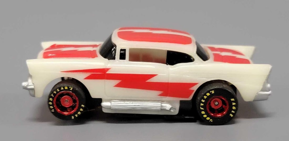 Tyco HO 57 Chevy glow in the dark Slot Car: Tyco HO 57 Chevy glow in the dark Slot Car The car is white with red lightning bolt decals. It features Goodyear Eagle tires with red rims and a nice chassis that shows little to no run time. This has