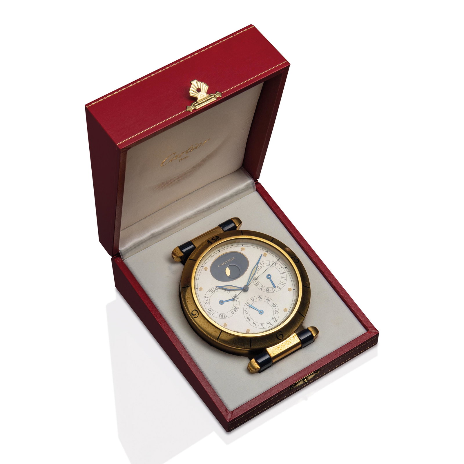 Cartier, desk clock: Desk clock with gilded metal case, perpetual calendar, and lunar phases. With quartz movement. It comes with its original box. Signed Cartier on the back. H13 x L10.5 cm (H5.12 x L4.13 in)