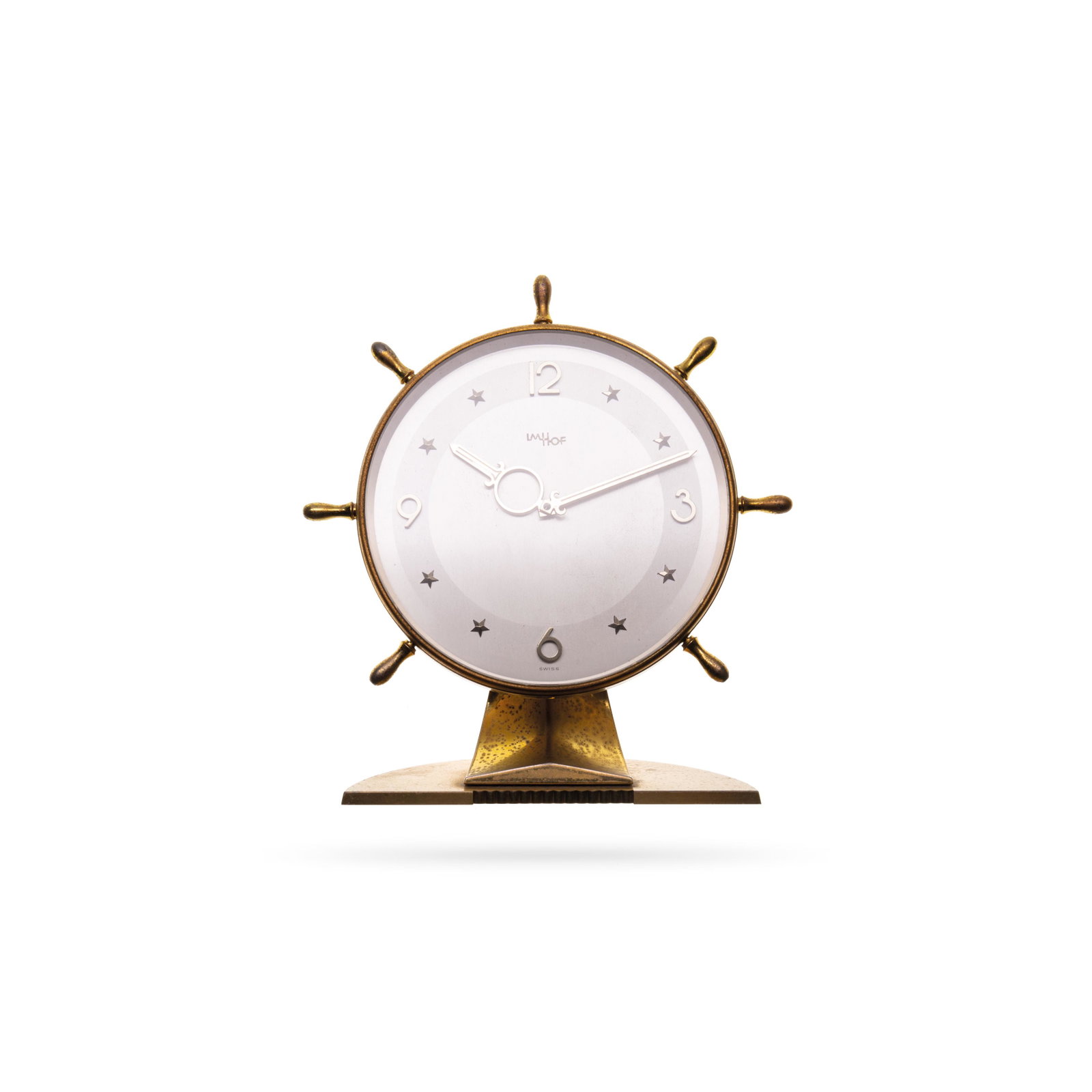 Table clock: Brass table clock in the shape of a ship wheel. Manual winding with 8 days of power reserve and alarm. IM HOF - Switzerland. H18 x L16 cm (H7.09 x L6.30 in), 1950/60
