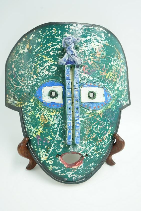 GILBERT PORTANIER MASK 1995 FRENCH: A Gilbert Portanier ceramic mask. Signed and Dated 95 French Ceramic with colorful splashes of paint and three dimensional applied clay over green paint . black trim along mask. Signed in black paint 