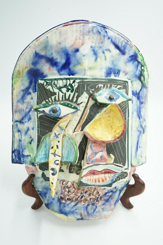 GILBERT PORTANIER CERAMIC MASK 1993 FRENCH: Gilbert Portanier ceramic mask. sculpture with applied three dimensional clay applications. Colorful paint applied in blues, pinks, yellow glazed with mat areas of black. signed and dated on the lower