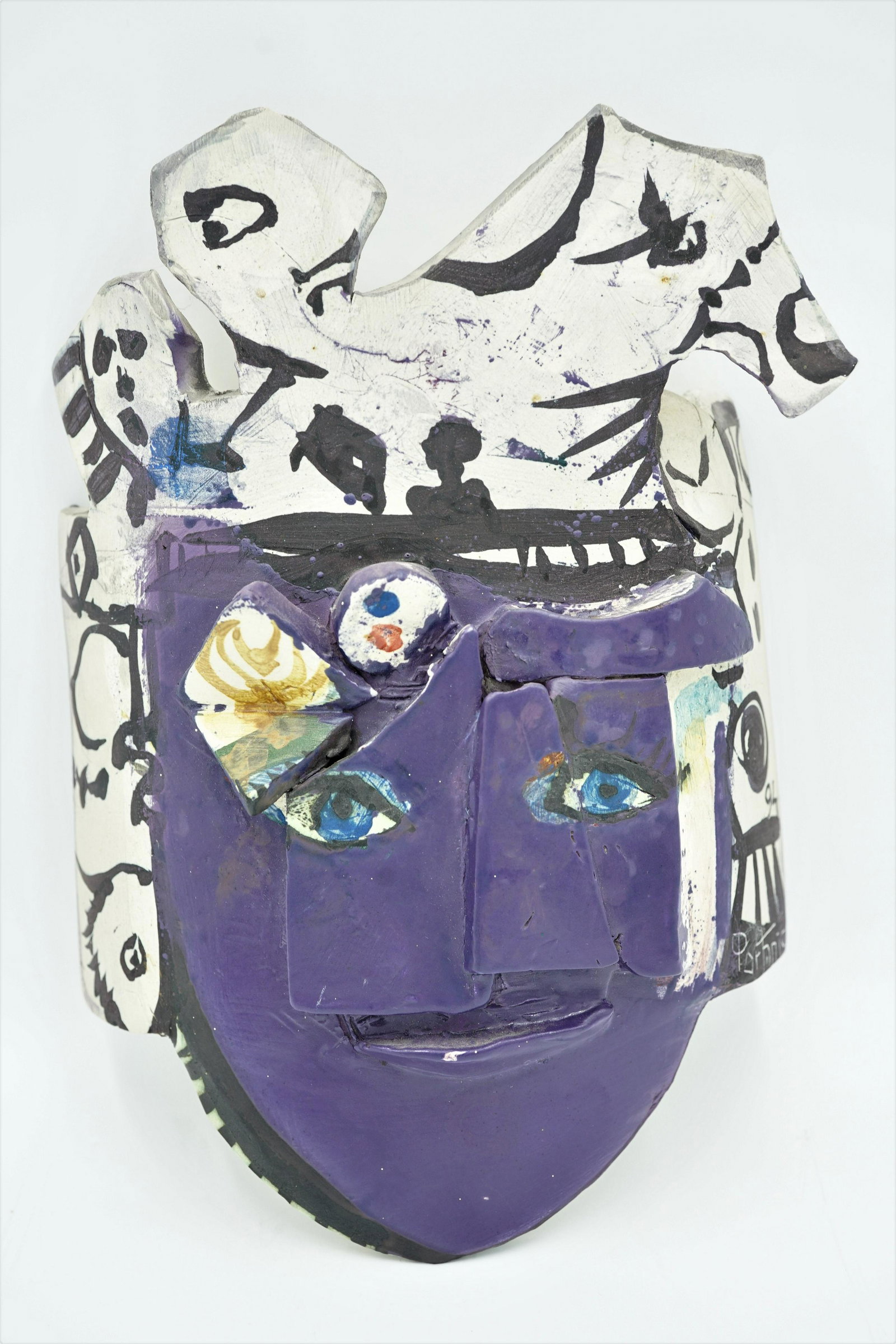GILBERT PORTANIER CERAMIC MASK 1994 FRENCH: A Gilbert Portanier ceramic mask signed and dated lower right Portanier 94Primary colors of purple and white with splashed of color and applied clay in three dimensional.There is ceramic bar across th
