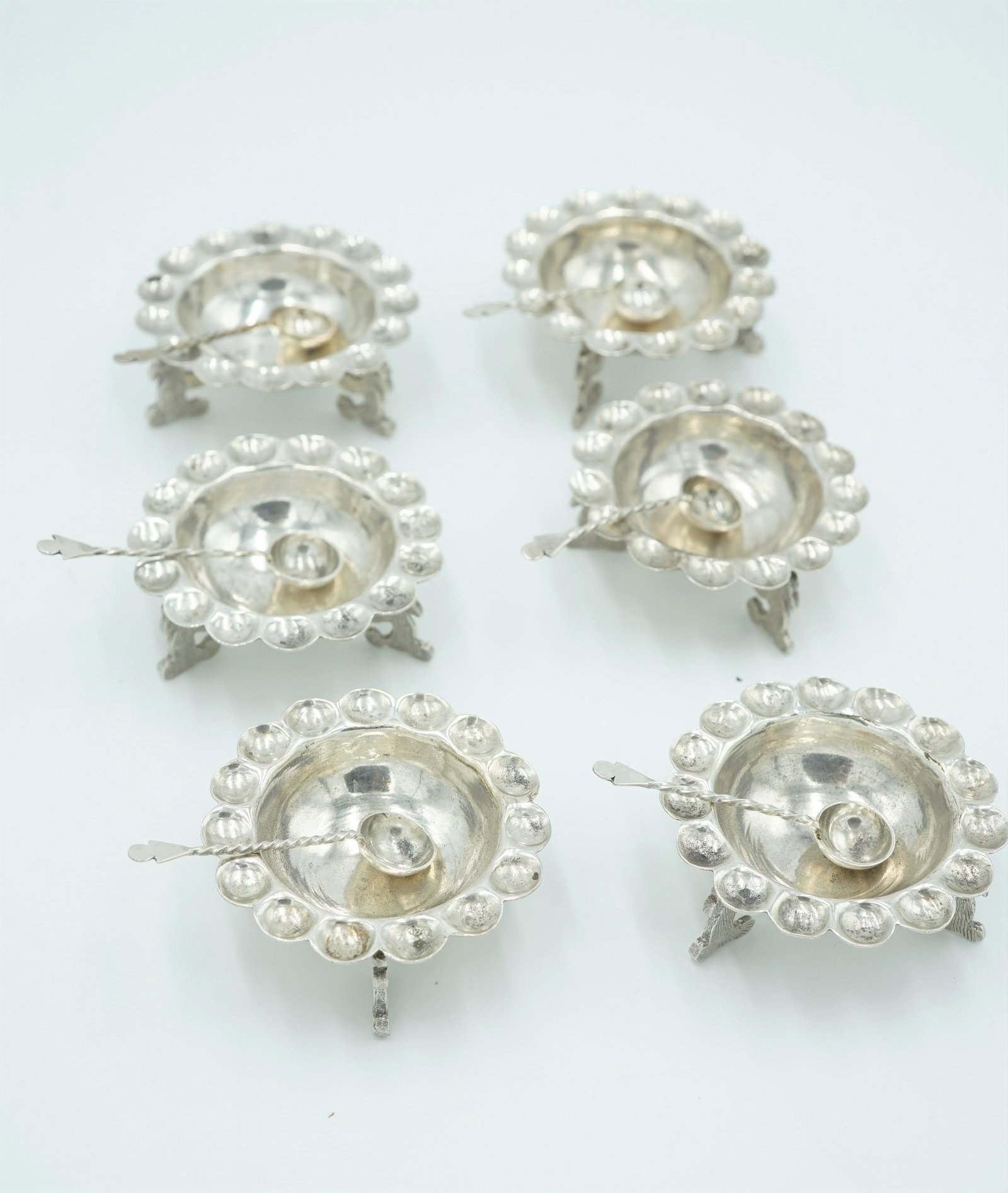 SANBORNS MEXICAN SALTERS SET ENGRAVED WOLF SUPPORTS: A set of six salter stamped Sanborns Mexico Sterling on the base with the owl hallmark.The bowl of the salter has engraved wolf figures. handcrafted wells that are along the rim. Each salter comes wit