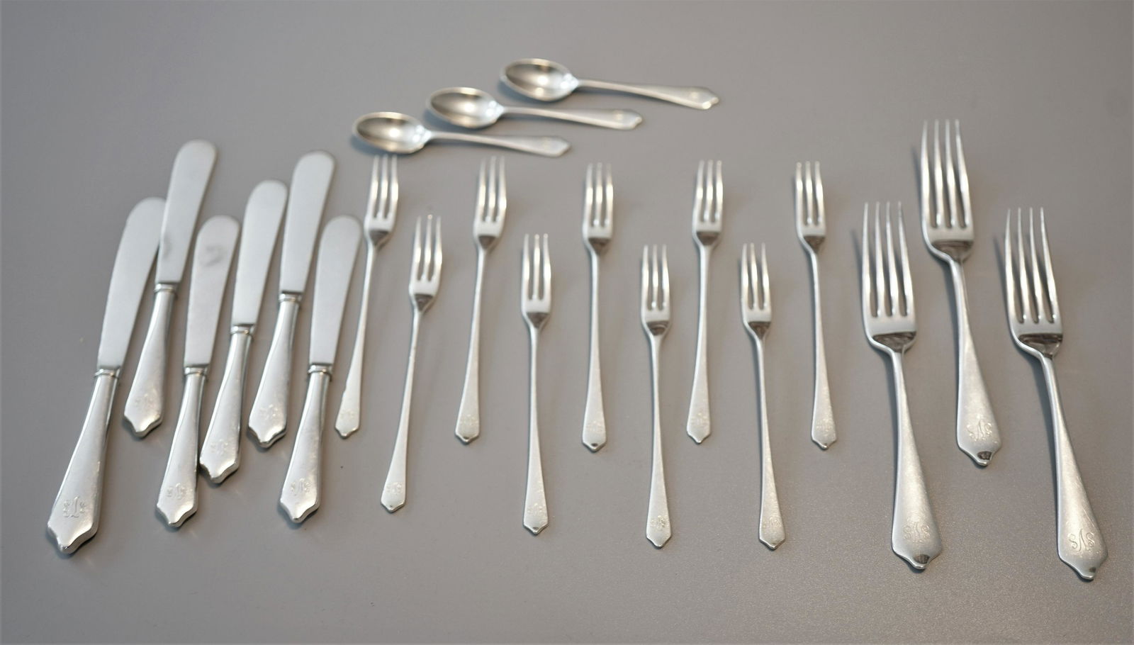 JAMES ROBINSON SILVER RELISH FORKS, BUTTER SPREADER: 159VJames Robinson England silver pattern of "Shield End" to include:Nine relish forks: 5 1/2" monogrammed in scroll SVS stamped on back of handle W, leopard, lion facing left and engraved James Robin