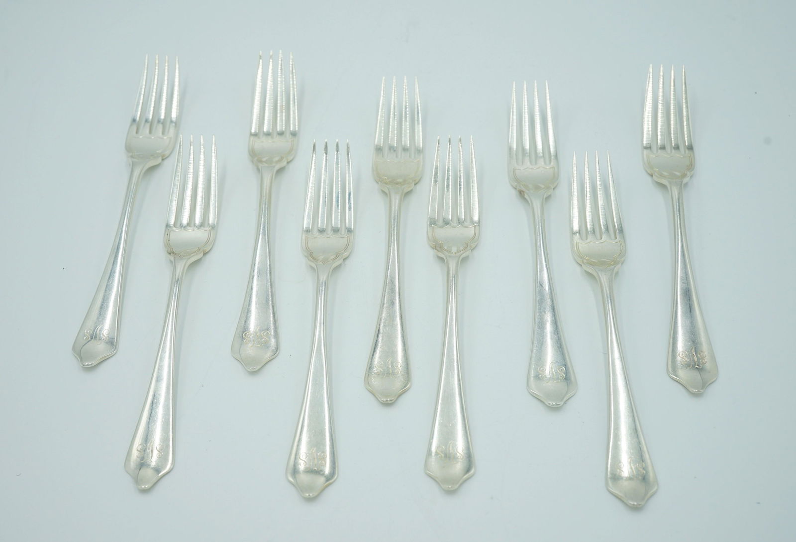 JAMES ROBINSON DESSERT FORKS "SHIELD END" Nine: James Robinson dessert forks set of nine. scrolled monogram on the handle of SVS stamped on back of handle James Robinson England. letter h leopard and lion facing left hallmark (FR) engraved shield o