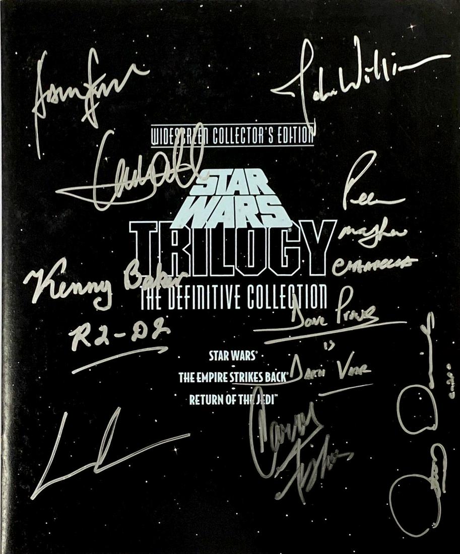 Star Wars Trilogy Picture Book Autograph Signed: Autographed by: Mark Hamill, Carrie Fisher, Harrison Ford, Dave Prowse, Anthony Daniels, Kenny Baker, Peter Mayhew, George Lucas, John Williams All items come with COA which has professional authentic
