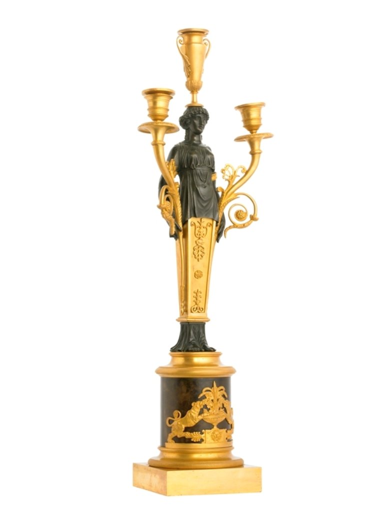 A Pair of Candelabras: A Pair of Empire Ormolu and Patinated Bronze Three-Light Candelabra replaced elements, Regilt. Each with a draped female caryatid flanked by curved candle branches cast with foliate rinceaux and with