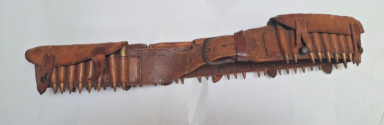 BOER WAR. British Army Martini-Henry Bandolier: South African made bandolier.Maker marked to P.BARNETT & SON PORT ELIZABETH.Dummy wooden carved bullets are used to display with the belt
