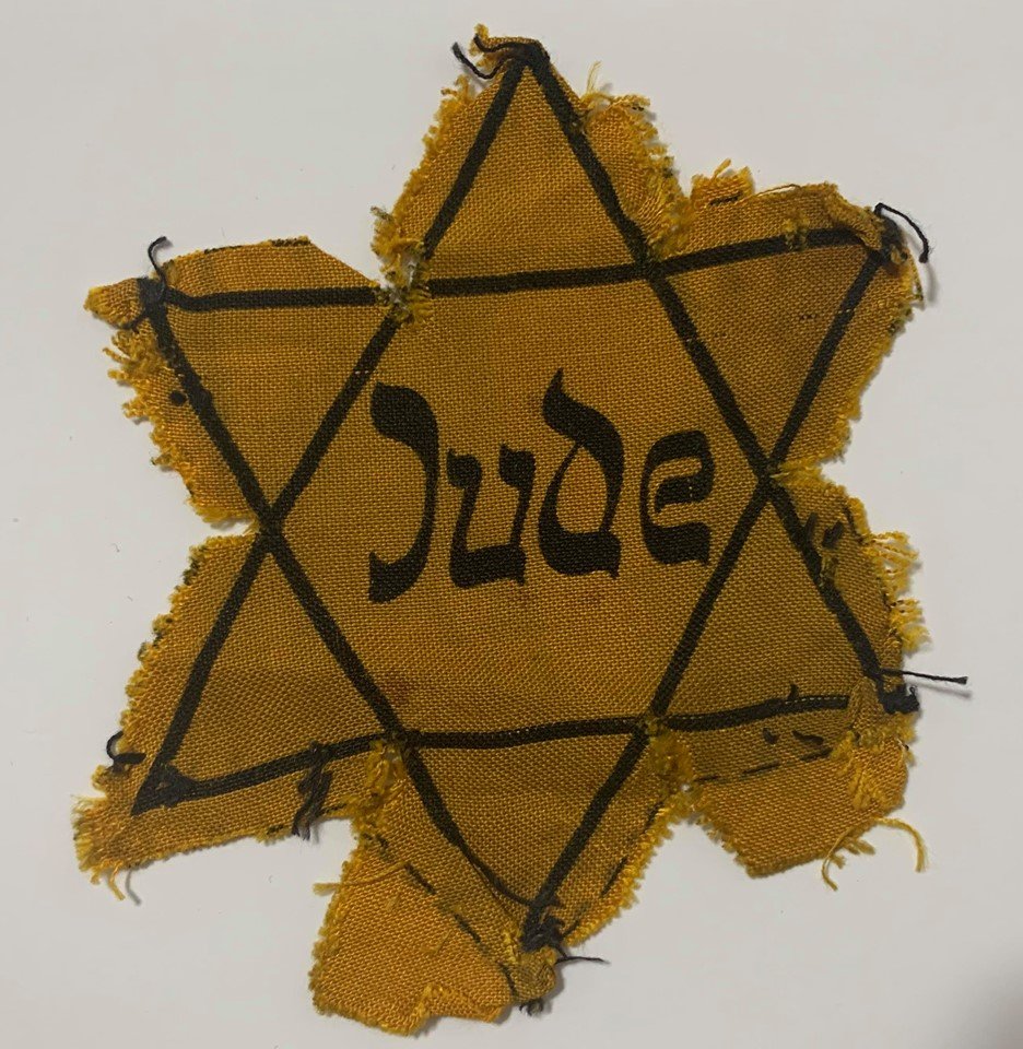 "Jude" Star of David Badge - Used - Holocaust: A genuine yellow Star of David in its JUDE version, like those used by Czech and German Jews during the Third Reich period, These were worn so Jews could be identified and persecuted by Nazi authoriti