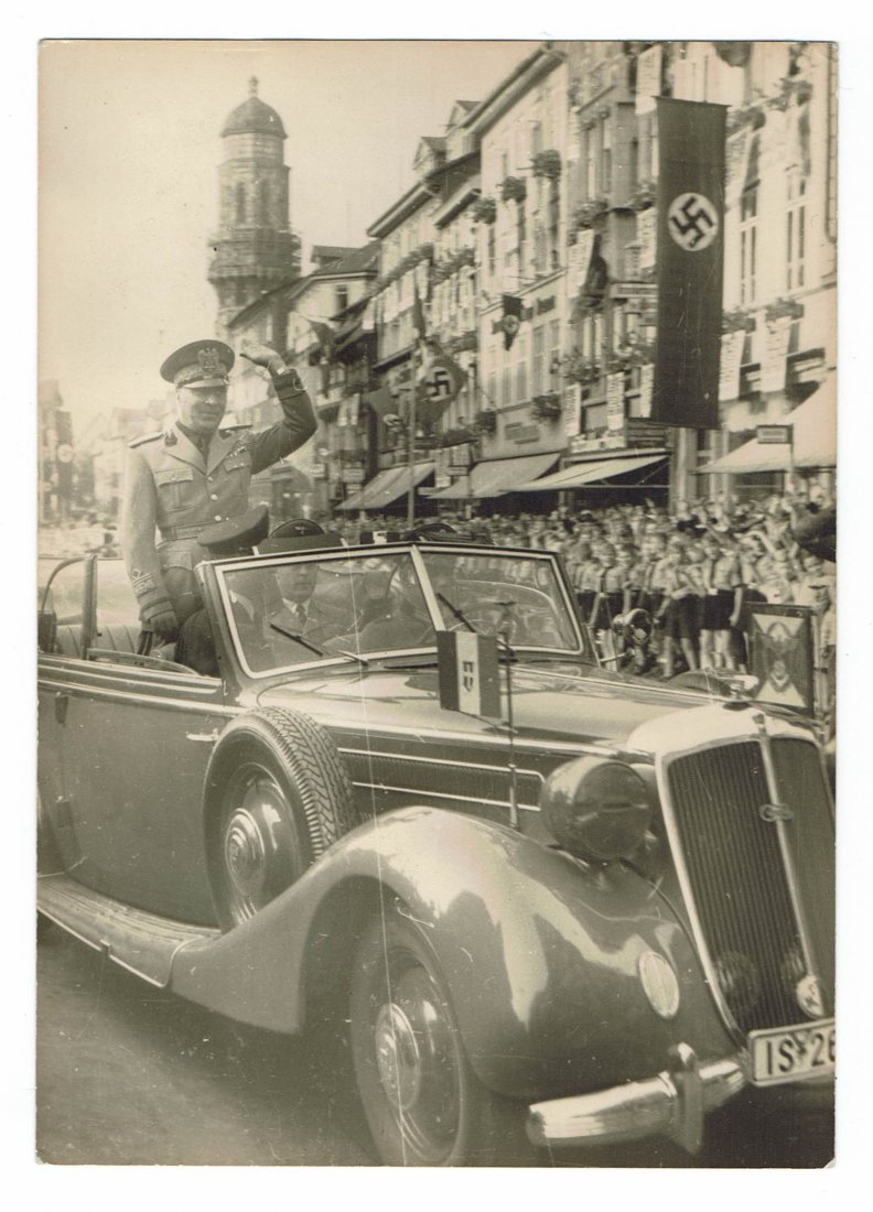German WWII - Photo of Mussolini in Germany: 12,5 cm x 17,5 cm - One of one of the visits of Mussolini's Foreign Minister to Nazi Germany saluting the crowd from a car. We can see Italian Fascist flag and some Nazi pennants and flags on building