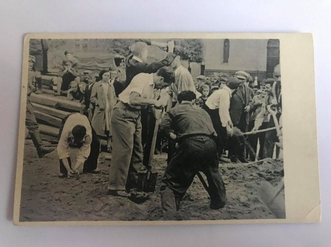 Anti Semitic Postcard Jews Working - Lodz WWII: Anti Semitic propaganda postcard showing some Jews forced to work on trenches. Description on the back "Polish theater of war Jews fill up the air-raid trenches on Freedom Square in Lodz, which had to