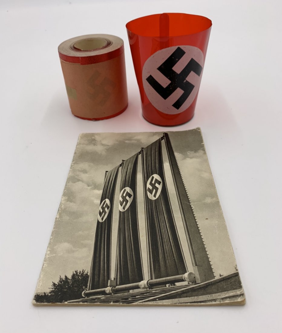 German Souvenir Cup, Nuremberg Booklet, Swastika Foil: German Souvenir Cup with swastika, Nuremberg Booklet, and 39 feet of unused Swastika Foil with original wrapping.