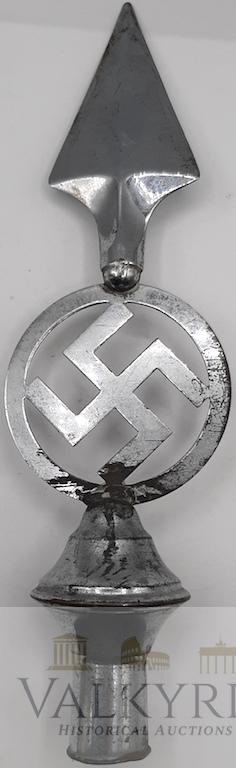 German Nazi Third Reich Flag Pole Top NSDAP Swastika: Flagpole top NSDAP. Copper construction with a nickel finish featuringa hollowspearhead on top of a swastika in a circle on top of a bulbous finialhollow end where thewooden pole would be inserted. Th