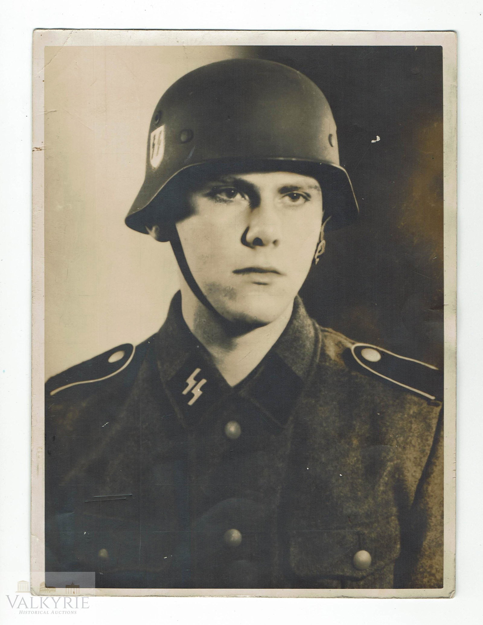 Big Size Period Portrait of SS Mann With Helmet & Runes: Big size period portrait of an SS Mann wearing his SS uniform of the Waffen SS and his SS helmet, where Sig runes' decal is perfectly visible. Ideal for SS soldiers' portrait collectors. Big size phot