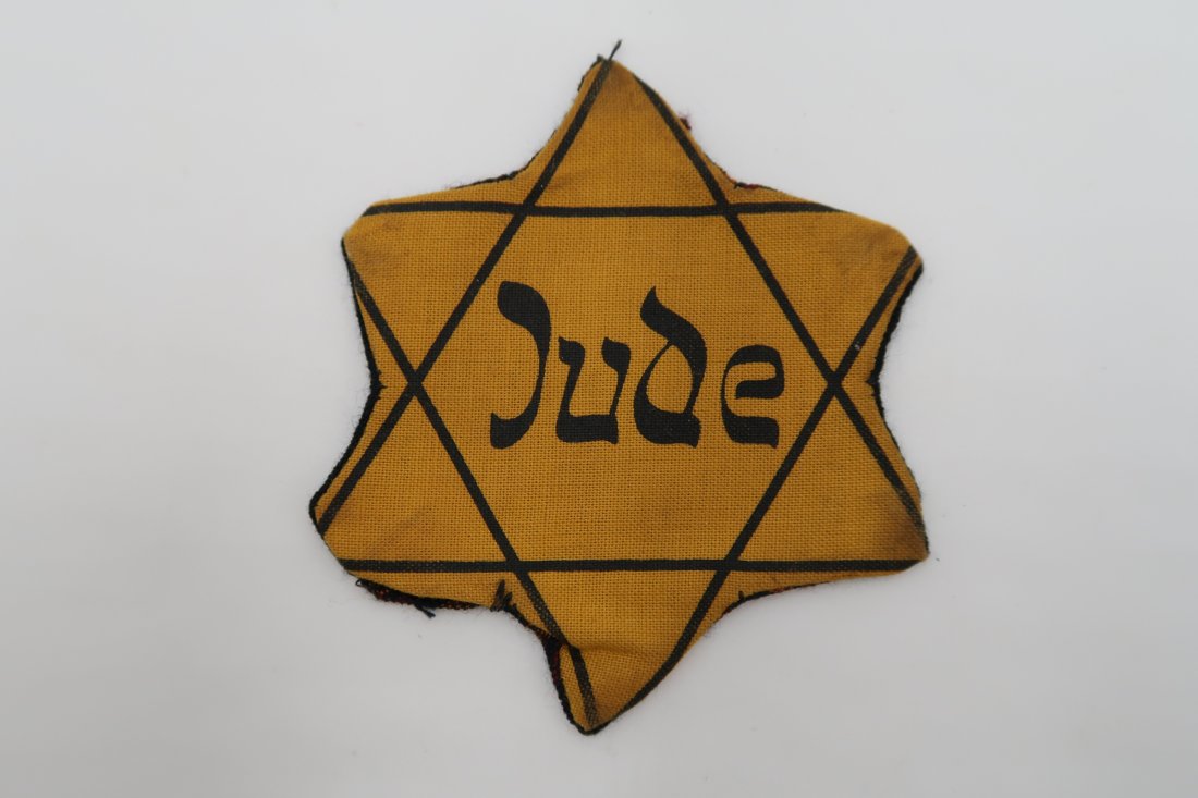 JUDE Star of David Badge: JUDE Star of David Badge, this example is a highly desirable variation with a cloth backing attached, indicating it was worn / used.. These cloth backings were added by the owners of the stars to make