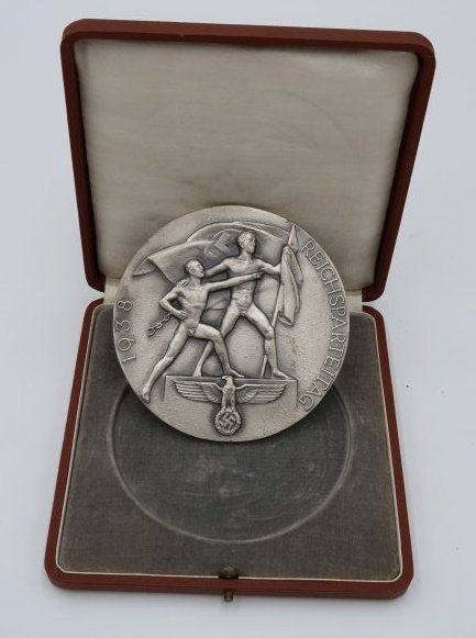 Nurnberg Reichsparteitag Table Medal 1938 Games Silver: These table medal commemorates a contest performed at the annual rally of the NSDAP party held in Nürnberg from 1923 to 1939 known as the “Nürnberg Rallies”.They were large propaganda events hel