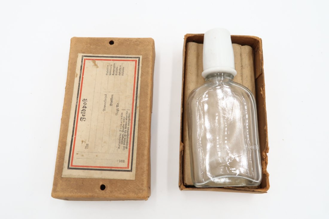 Glass Bottle With Original Cardboard Felpost Box: Unused and never sent empty glass bottle of the WW2 period with the original cardboard box for Feldpost with the unfilled label glued. Bottle came inside the box as it is shown. Maybe a way to send to