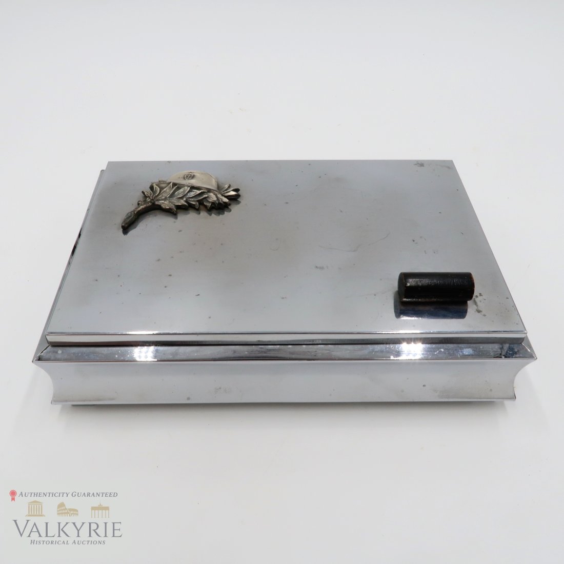 Third Reich Nazi Wehrmacht Metal Cigar Box: Third Reich Nazi Wehrmacht Metal Cigar Box, possibly for personal belongings. The top has a helmet and flower in the upper left. Excellent condition. Measures about 8 inches x 5.5 inches.