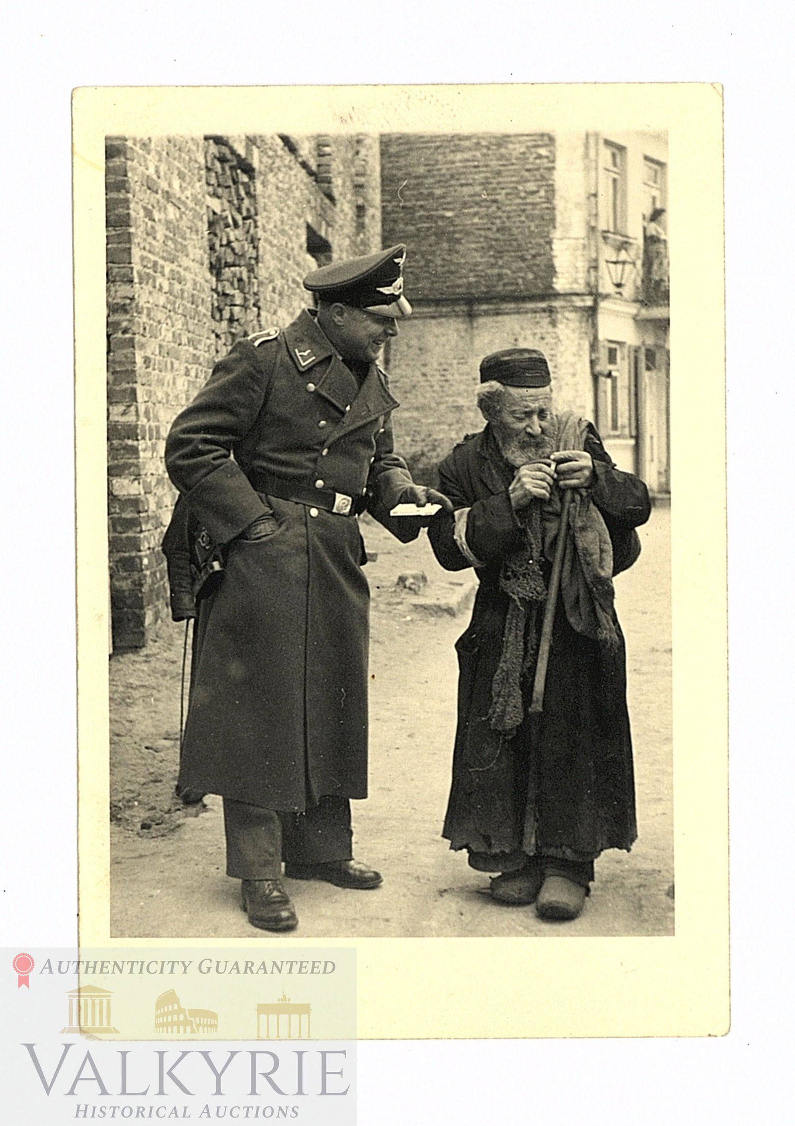 Rare Photo of Luftwaffe Officer Giving a Cigarette to an Elderly Jew in Delin-Irena Camp: Rare photo where we can see a Luftwaffe officer talking with an elderly and poor Jew while he gives the old man a cigarette. This photo, as described on the reverse, was taken in Deblin - Irena in the