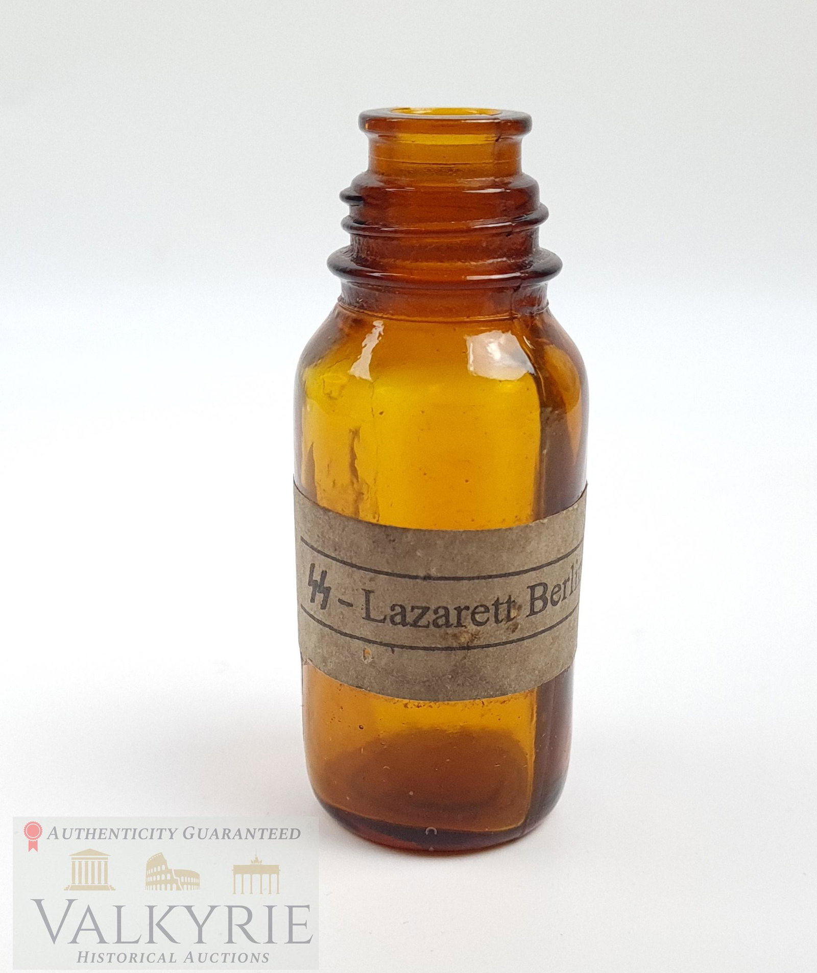 Empty Crystal Bottle of Medicine With Label of SS-Lazarett Berlin: Empty crystal bottle of an unknown medicine with a label that says "SS-Lazarett Berlin", from the SS hospital in the capital of the III Reich. *******This article is sent from our office in Europe****