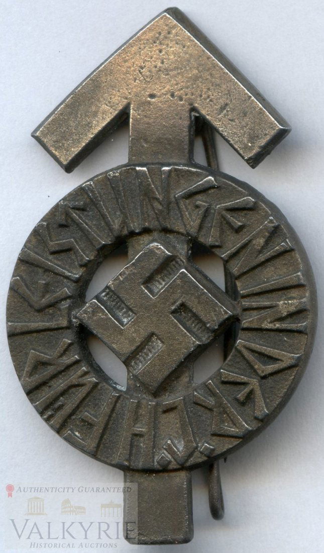 HJ Proficiency Badge RZM M 1/63 B: HJ Proficiency Badge RZM M 1/63 B HJ - Leistungsabzeichen. The stamped, polished alloy award is in the form of a Tyr-rune with a circle superimposed to it, upon which is embossed, in runic script, "F