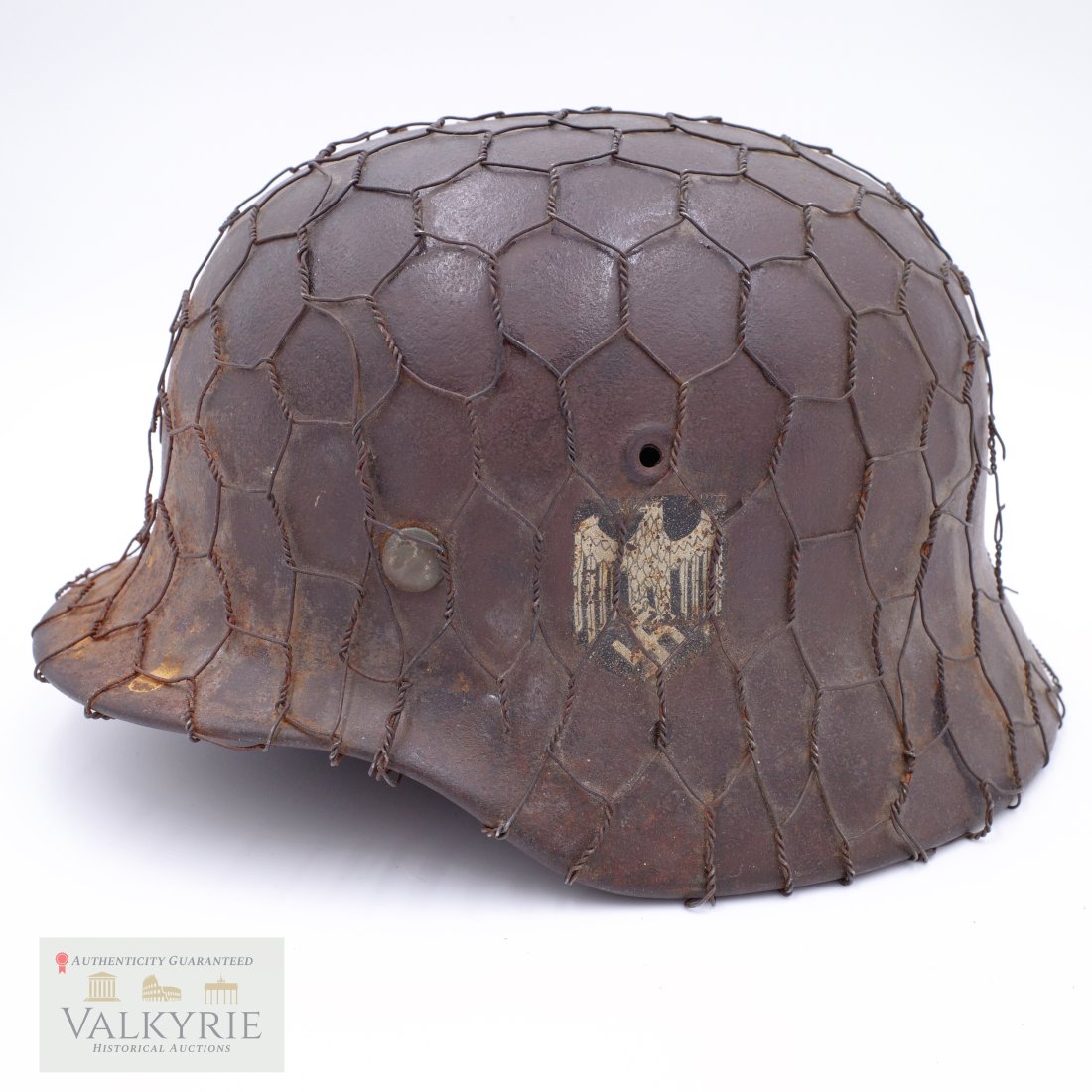 German Heer M40 Helmet with Chicken Wire Camo - Owner Named: German Heer M40 Helmet with Chicken Wire Camo. It's Owner Named on the inside in red paint, H. Dietz and the number "109". The helmet is all original, untouched and was found in Normandy in a farmhous