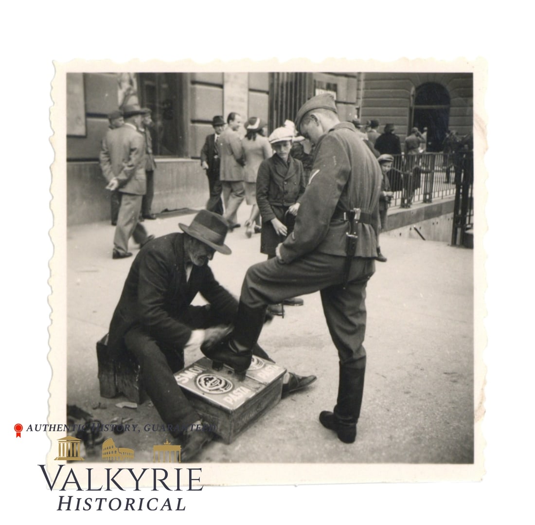 Photo Showing a Polish Man Cleaning a German Soldier's Boots in Warsaw During Occupation: Photo Showing a Polish Man Cleaning a German Soldier's Boots in Warsaw During Occupation. Size: 6x6cm. Shipping from our office in Europe.
