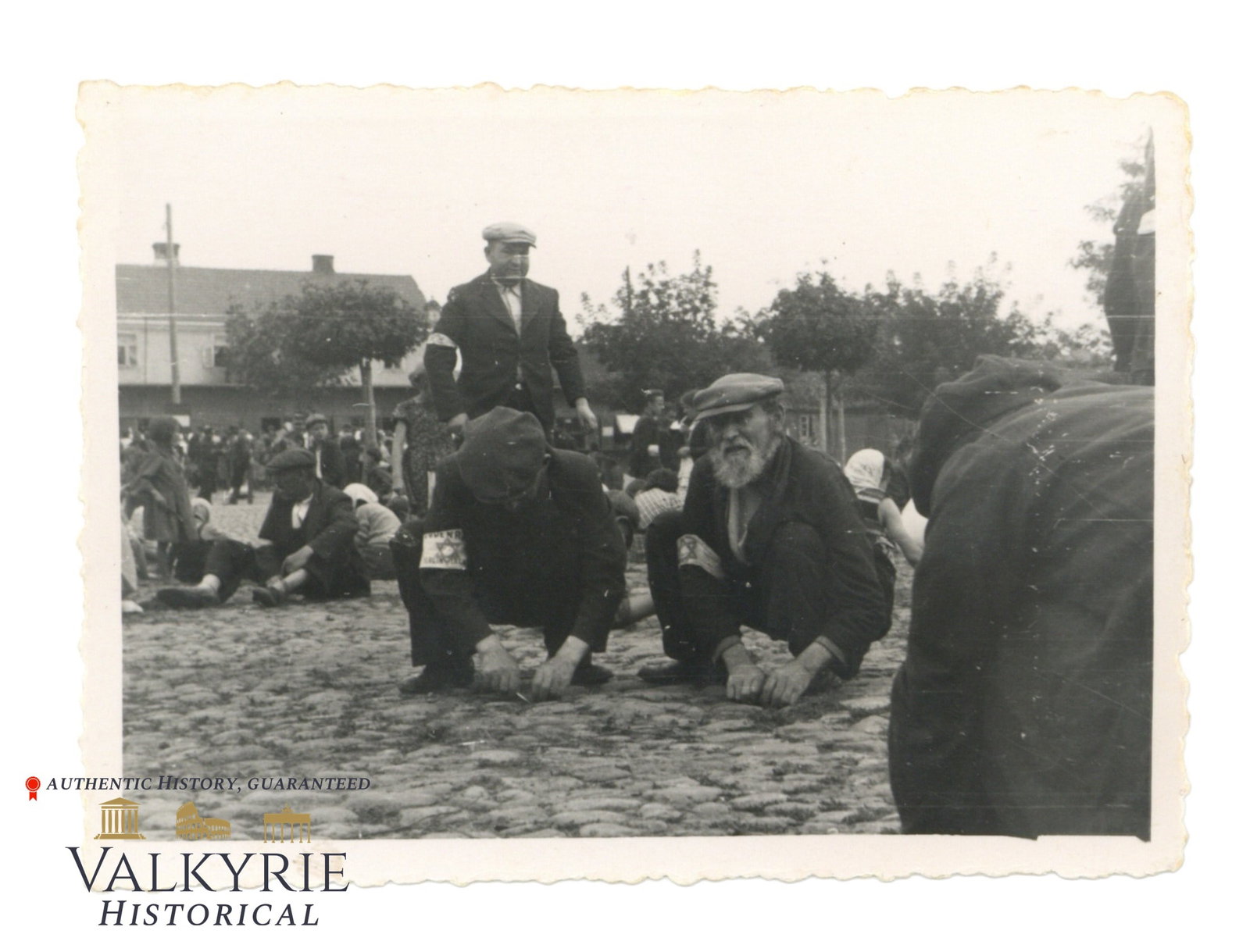 Photo of Deblin Ghetto Jews Wearing the David Star Armband Forced to do Denigrating Works: Photo of Deblin Ghetto Jews Wearing the David Star Armband Forced by the Germans to do Denigrating Works. Some of the Jews, most probably Polish, seem to be cleaning the stone pavement in some Jewish 