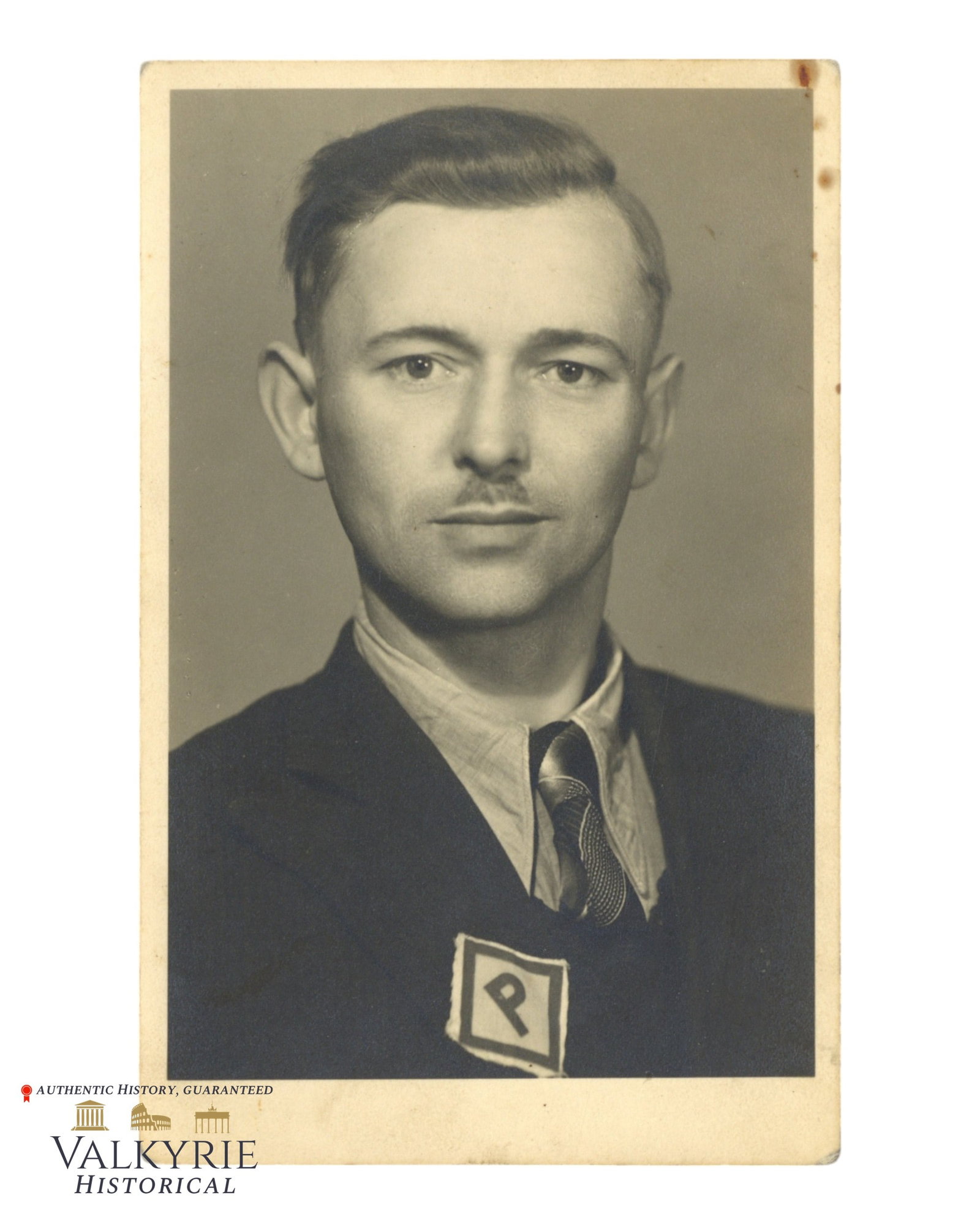 Studio Photo in Postcard Size of a Pole Who Was Used as Forced Labourer Wearing P Patch: Studio Photo in Postcard Size of a Pole Who Was Used as Forced Labourer Wearing P Patch that Polish forced labourers must wear to be identified. On the reverse ink stamp of the photographer. Size: Pos