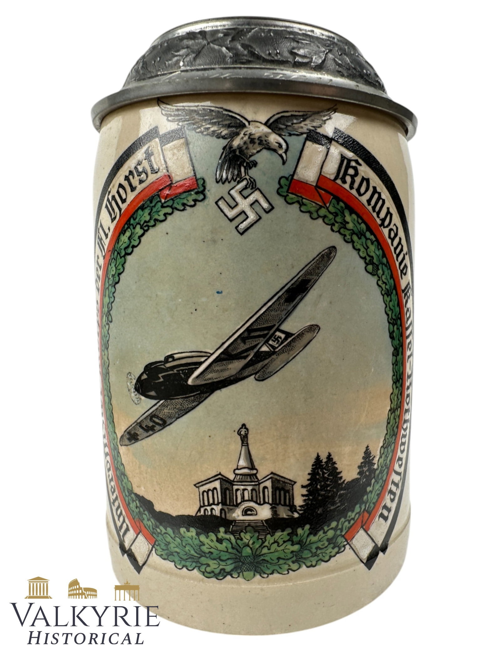 German III Period Comemmorative Stein of the "Unteroffizier K. Fl. Horst Kompanie Kassel-Rothwesten": German III Period Comemmorative Stein of the "Unteroffizier Korps Fl. Horst Kompanie Kassel-Rothwesten". Beautifully decorated with Luftwaffe motivs and eagle. Metal lid. All items for this auction wi