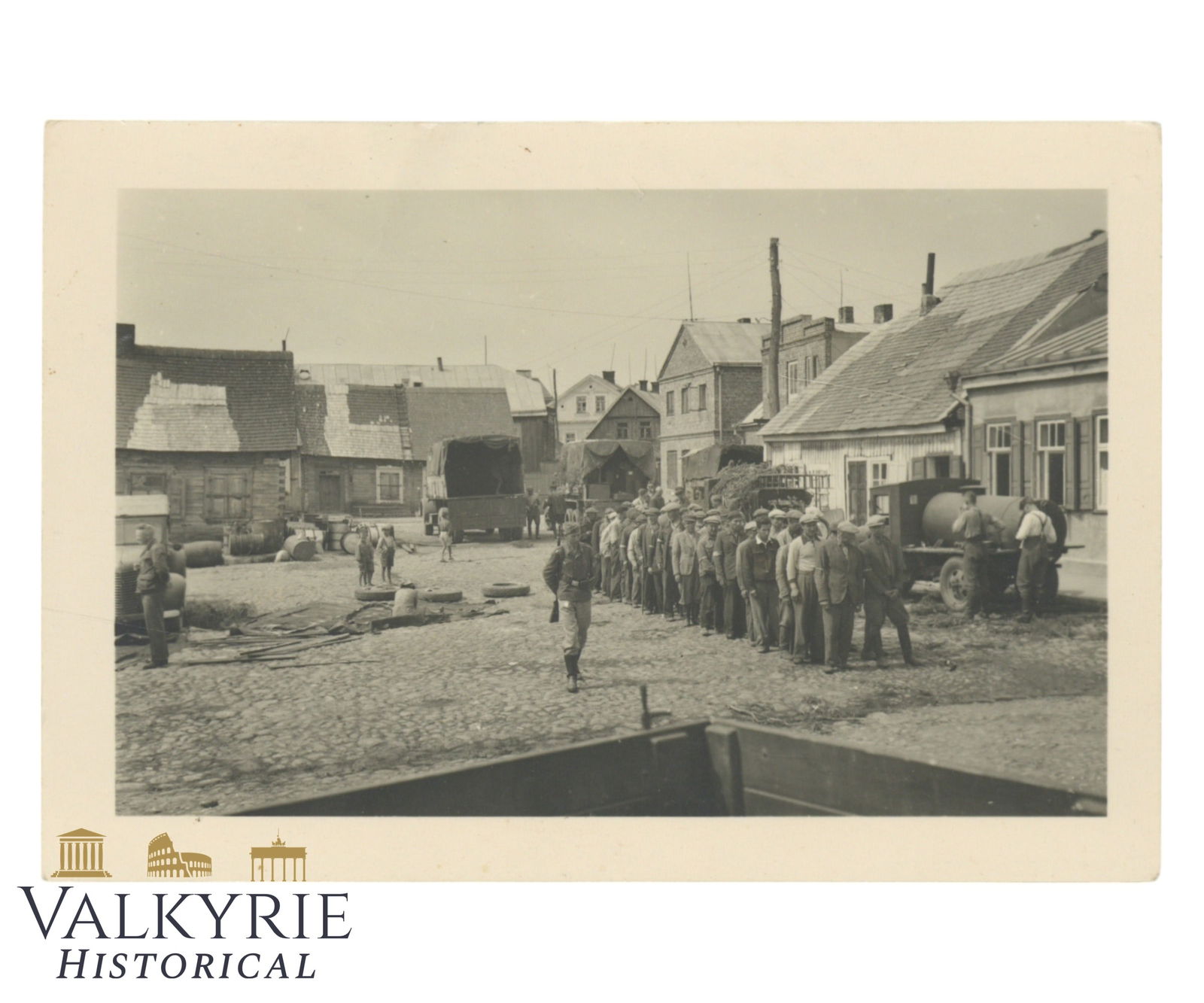 Private Taken Photo of Some Jews Forced to Queue-up Probably Before Marching to Work in Poland: Private Taken Photo of Some Jews Forced to Queue-up Probably Before Marching to Work in Poland. A German soldier is watching them. Removed from album and described on the reverse. This photo was publi