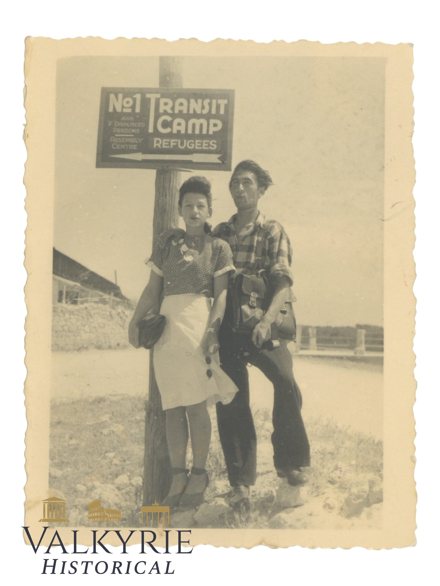 Post-war Taken Photo of a Couple Posing With a Sign Indicating a Transit Camp For Refugees: Post-war Taken Photo of a Couple Posing With a Sign Indicating a Transit Camp For Refugees. The couple seem to have been in that camp just after the war. On the reverse the photo is described by Greek