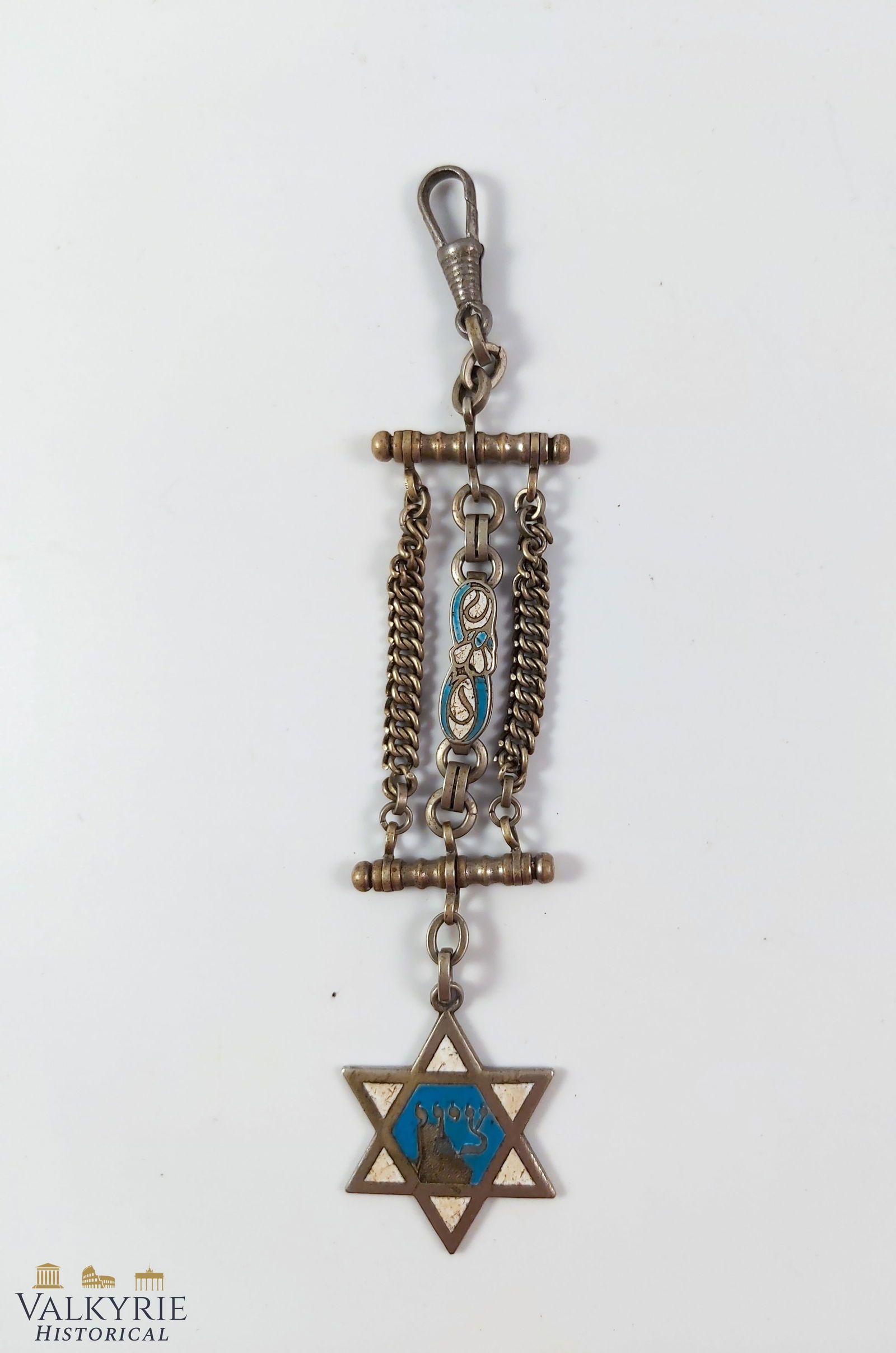 Judaica Star of David Keyring in Alpaca and Enamel: Jewish judaica keyring made from alpaca and enamel that show Jewish motifs such as the star of David which has some of the enamel broken. These items were common among the Jewish communities in Europe