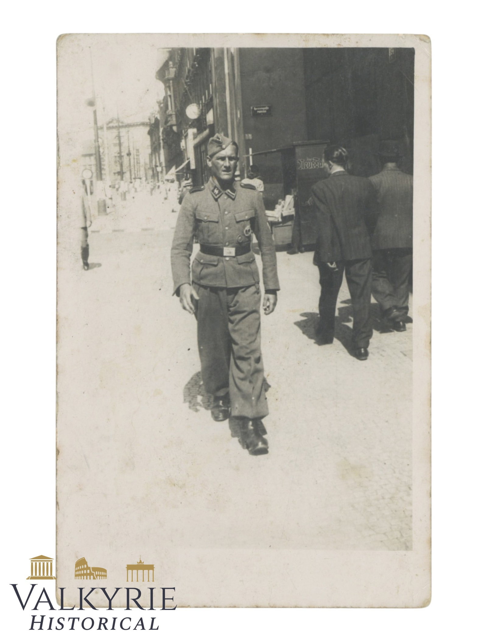 German Postcard Size Photo of a German Waffen SS Unterscharfuhrer Walking in the Streets in Europe: German Postcard Size Photo of a German Waffen SS Unterscharfuhrer Walking in the Streets in Europe. Size: 13,5x9cm Shipping flat cost $25 it doesn't matter how many items you win. you pay just $25