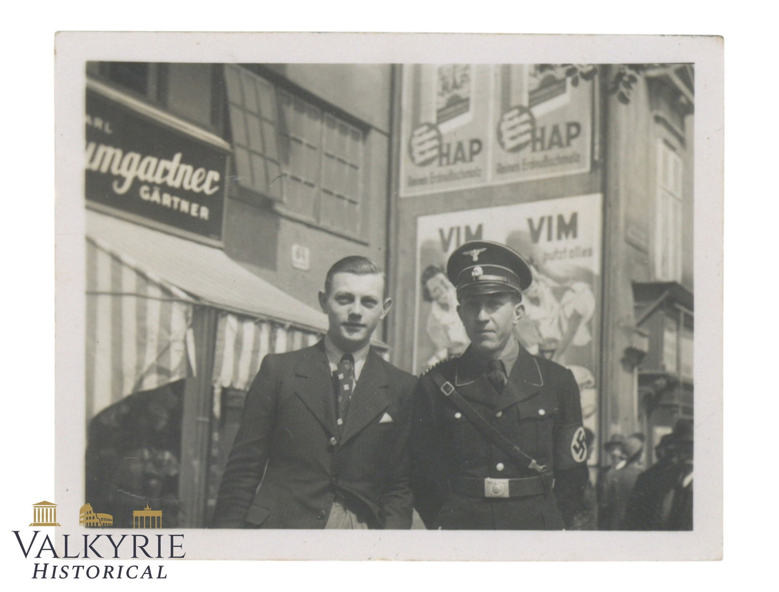 Private Taken Photo of an SS Allgemeine Member With a Friend or Relative in The Streets of Germany: Private Taken Photo of an SS Allgemeine Member With a Friend or Relative in The Streets of Germany. Removed from photo album. Size: 6x5cm Shipping flat cost $25 it doesn't matter how many items you