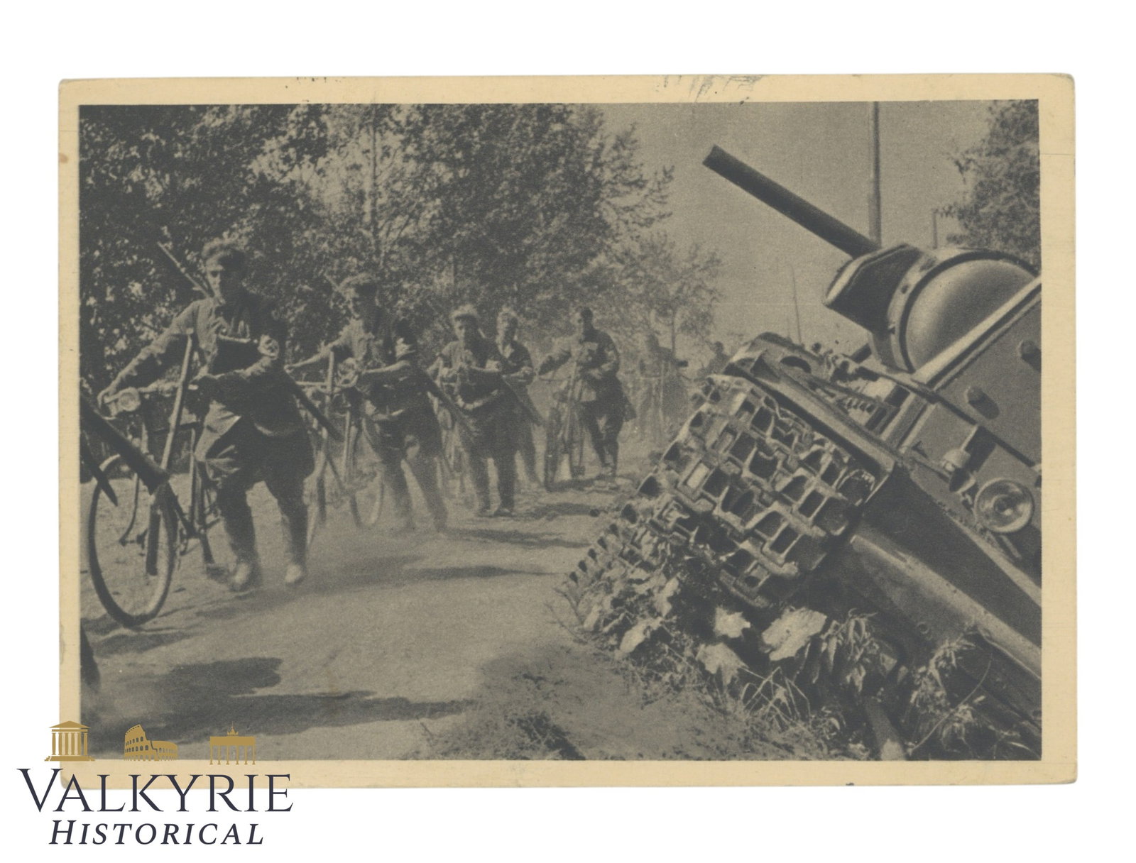 German Postcard With Photo of Some Wehrmacht Soldiers With Bicycles Marching in the Front During WW2: German Postcard With Photo of Some Wehrmacht Soldiers With Bicycles Marching in the Front During WW2. An enemy tank destroyed is also visible. Sent as Feldpost by a German soldier in 1942. All items f