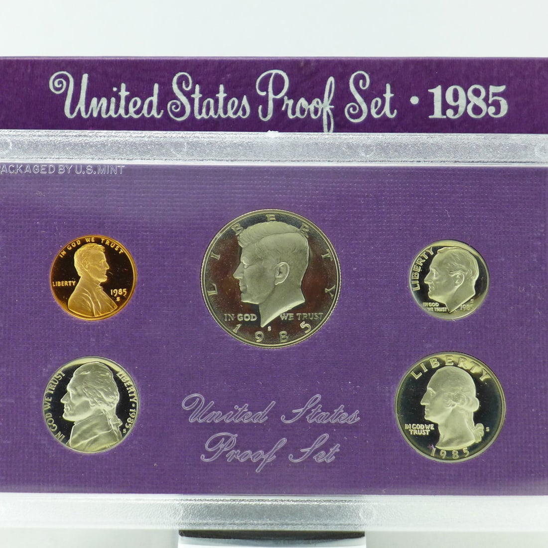 1985 United States Proof Set, 5 Coins Inside!: 1985 United States Proof Set, 5 Coins Inside!. Original packaging: The coins of the 1985-S Proof Set were placed in individual holes in a purple-colored, textured paper and cardboard insert, then seal