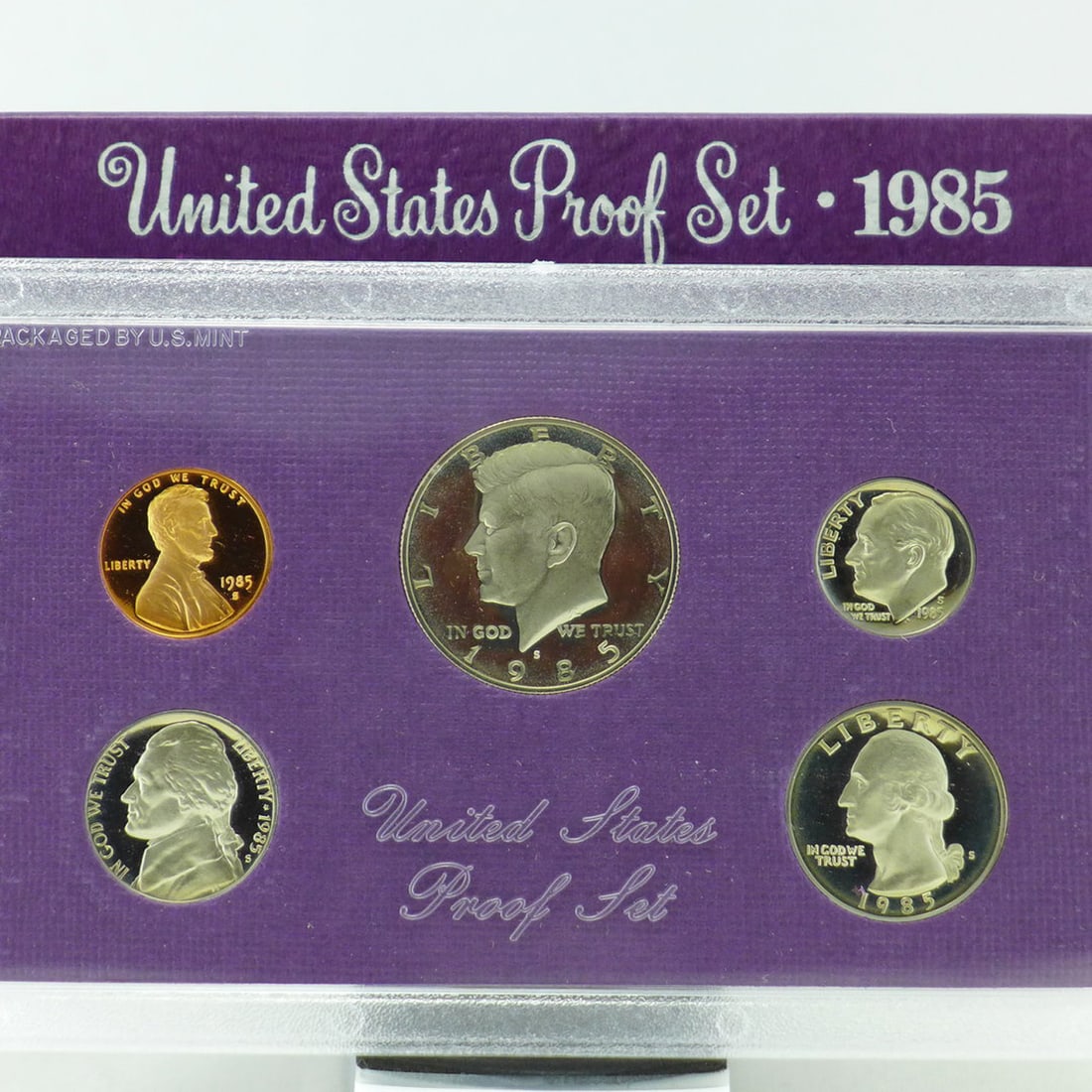 1985 United States Proof Set, 5 Coins Inside!: 1985 United States Proof Set, 5 Coins Inside!. Original packaging: The coins of the 1985-S Proof Set were placed in individual holes in a purple-colored, textured paper and cardboard insert, then seal