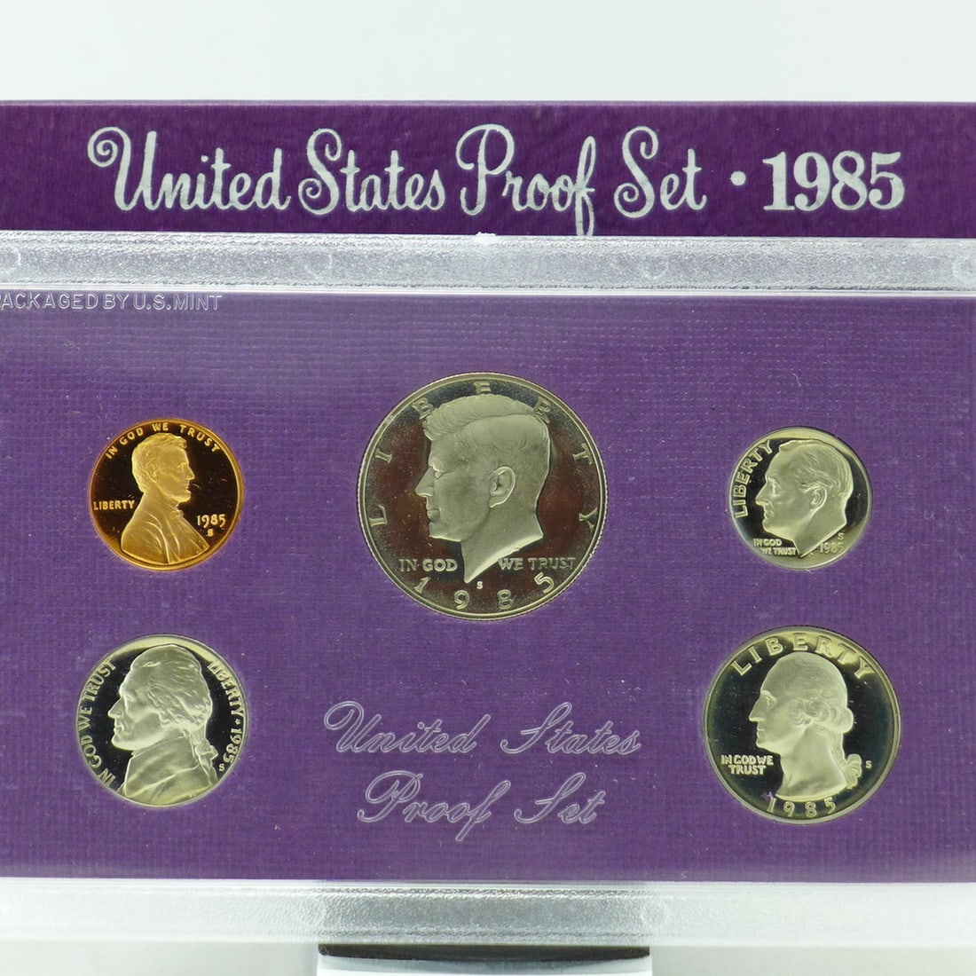 1985 United States Proof Set, 5 Coins Inside!: 1985 United States Proof Set, 5 Coins Inside!. Original packaging: The coins of the 1985-S Proof Set were placed in individual holes in a purple-colored, textured paper and cardboard insert, then seal